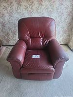Front view of burgundy leather La-Z-Boy recliner showing full chair and seat card
