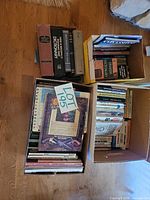 Three boxes of mixed books in various sizes and subjects