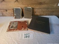 Group shot of all four books showing titles and relative condition