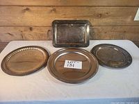 Group shot of all four silver-plated trays and platters