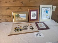 All five pieces arranged on table showing frames and needlepoint