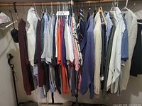 Hanging garments on closet rod including shirts, sport coats, sweaters and ties