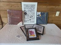 Overall lot showing frames, album, poster, certificate folders