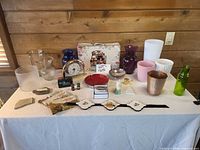 Full lot on tabletop showing clock, vases, planters, books and small decor