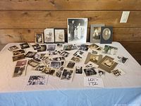 Overview of entire assortment of photographs spread on table