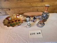 Full view of seven ceramic items on table