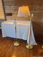 Full view of both brass floor lamps with shade