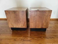 Front view of both cube side tables on wooden floor