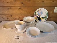 Full lot overview showing plates, bowls, platter, cup & saucer, decorative plate
