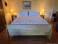 Full view of assembled bed with side tables, lamps, artwork