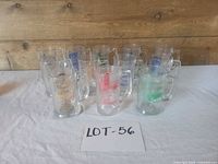 Group view of all 12 printed glass mugs