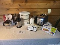 All eight items on tabletop against wood wall