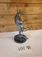 Front view of brass otter sculpture showing pose and patina