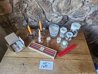 All candles and holders arranged on table for overview