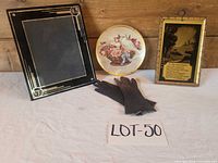 Group shot of all four items: gloves, decorative plate, framed poem, black & gold frame