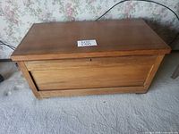 Closed blanket chest front view showing panel design and lock