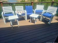 overview of chairs, tables and cushions on deck