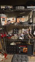 Shelf with assorted pans, tart pans, springform, bundt pan