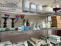 shelving showing multiple candle holders, boxed items and accessories