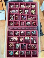 Full tray showing approximately 40 pairs of assorted earrings