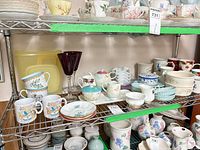 shelving with assorted porcelain, ceramic and glass tea and serving pieces