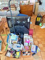 Overview of lot showing greeting card boxes, office supplies, phone and flashlight