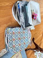 Stack of patterned melamine trays, white tray, boxed trays partially visible