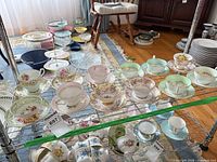Wire rack showing multiple floral teacup and saucer sets