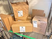 Stacked cardboard boxes containing Garden Melody mug set, teapot and vase