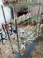 Full front view of chrome shelving loaded with dinnerware