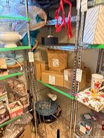 Full view showing chrome wire rack with shelves and assorted items for scale