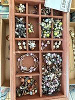 Tray showing multiple beaded bracelets, earrings and necklaces