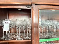 Cabinet view showing multiple crystal glasses on shelf