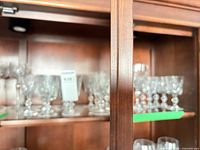 Cabinet shelf showing multiple diamond-cut crystal goblets