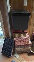 Stack of decorative and black storage boxes