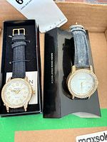 Front view of both Gruen watches in packaging