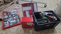 Overall lot with gift tag sheet, red boxes, napkin rings in crate, kitchen tools visible