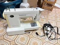 Full view of Kenmore sewing machine with foot pedal and cord