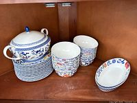 Full set showing tureen on dinner plates, two stacks of bowls, and oval dishes