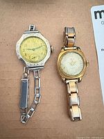 Front view of both wristwatches showing dials, cases and bracelets