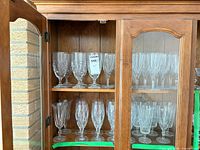 Cabinet view showing top and bottom shelves with assorted crystal stemware