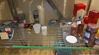 Full shelf view showing candles, spoons, napkin rings, decorative cord