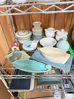 overview of mixed ceramic items on wire shelf