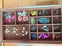 Tray overview showing assorted earrings, bracelets and necklaces