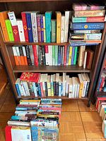 Wide view of three shelves and floor stack showing quantity and binding mix