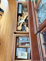 Open drawers showing wooden utensils, boxed serving spoon set and other boxed accessories