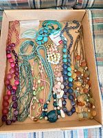 Full lot overview showing variety of necklaces in box