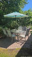 full view of patio set with umbrella extended