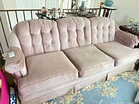Front view of pink tufted 3-seat sofa showing overall design and condition