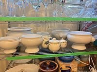Overall view of Bodum white tureens and bowls with Noritake sugar and creamer on shelf